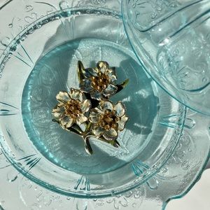 Gold toned leaf brooch and three flowered bouquet brooch with  blue flower